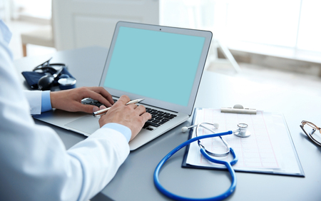 Male doctor at work in clinic officeの写真素材