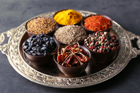 Different spices in bowls on trayの写真素材