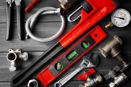 Plumber tools on a gray wooden backgroundの写真素材