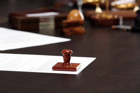 Wooden stamp and document on grey table