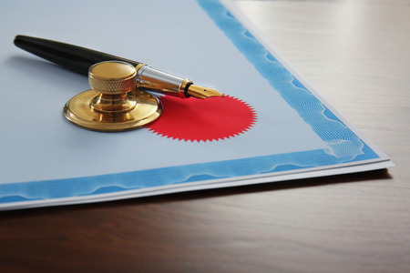 Pen, stamp and document on notary public table