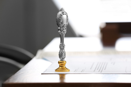 Metal stamp and document on notary public tableの写真素材