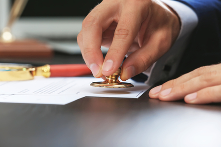 Notary public in office stamping documentの写真素材