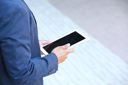 Lawyer  holding tablet on the street