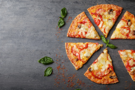 Tasty pizza slices on tableの写真素材