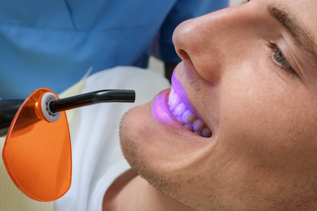 Dentist examining patient teeth in clinicの写真素材
