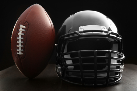 Rugby ball and helmet on dark backgroundの写真素材