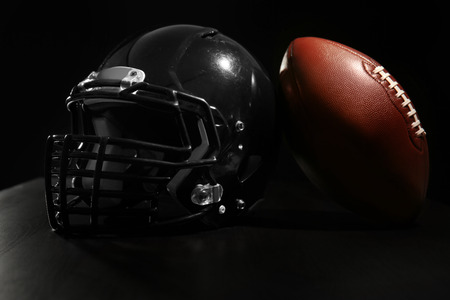 Rugby ball and helmet on dark backgroundの写真素材