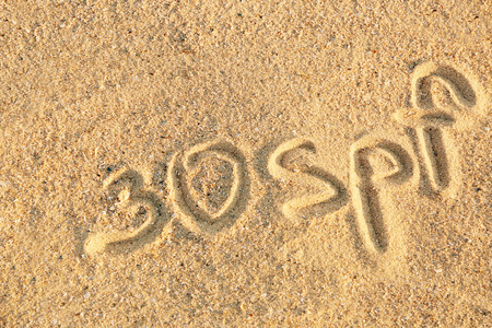 Handwritten inscription on sea sand, close up viewの写真素材