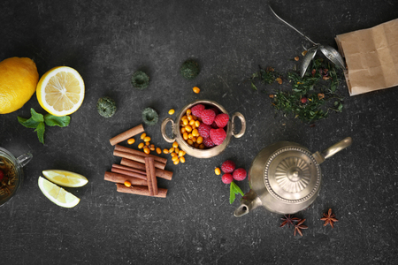 Fresh tasty tea ingredients and berries on grey backgroundの写真素材