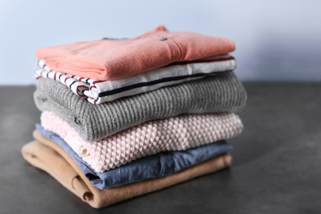Pile of clothes on tableの写真素材