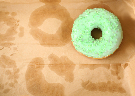 Delicious donut on greasy paper in boxの写真素材