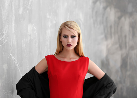 Pretty young blonde woman against grunge backgroundの写真素材