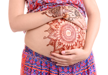 Henna tattoo on pregnant belly on white backgroundの写真素材