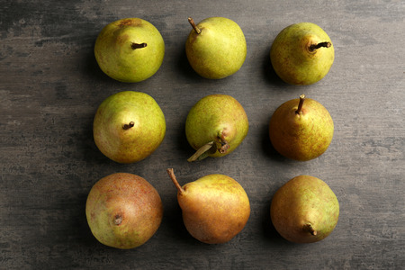 Green pears on grey background