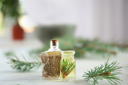 Bottles of pine essential oil on wooden tableの写真素材