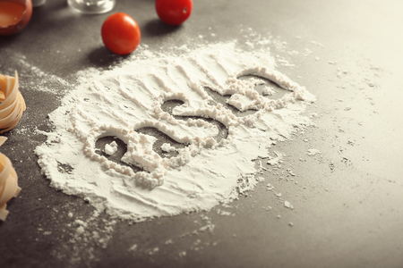 Word PASTA made with flour on kitchen table, close up viewの写真素材