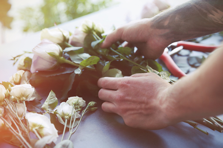 Male florist making bouquet at flower shopの写真素材