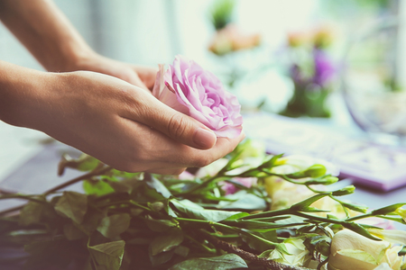 Female florist making beautiful bouquet at flower shopの写真素材