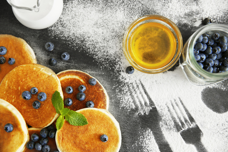 Scattered powdered sugar with delicious pancakes and blueberries, closeupの写真素材