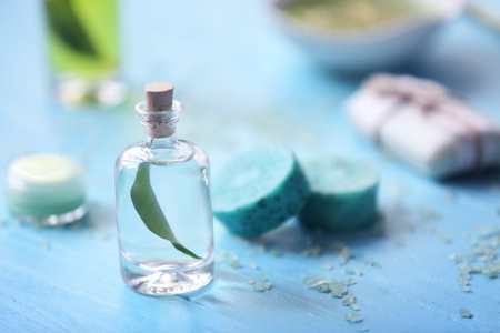 Spa concept. Aroma oil on blue blurred backgroundの写真素材