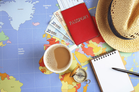 Traveller's accessories on world map background, top view. Travel planning concept