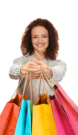 Happy woman holding shopping bags on white backgroundの写真素材