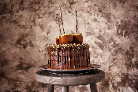 Tasty chocolate cake with apples on wall backgroundの写真素材