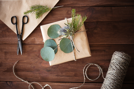 Handcrafted gift box with flowers on wooden tableの写真素材