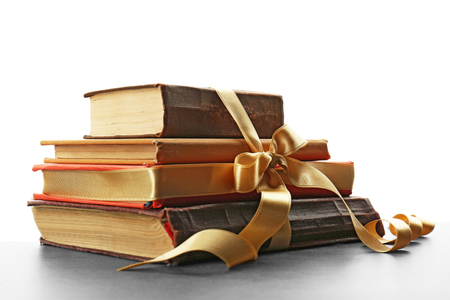 Old books tied in ribbon isolated on whiteの写真素材