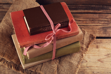 Old books tied in ribbon on wooden backgroundの写真素材