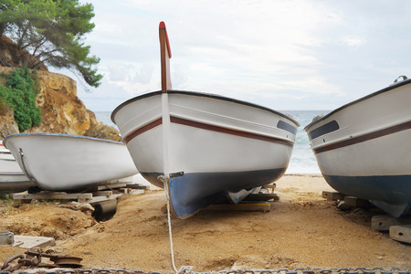 Close up view of boats on sand near seaの写真素材