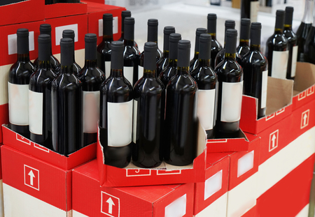View of shelves with alcohol bottles in supermarketの写真素材