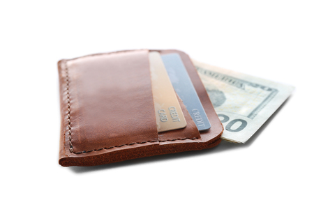 Brown leather wallet with credit cards and money isolated on whiteの写真素材