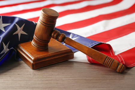 Judge gavel and American flag on tableの写真素材