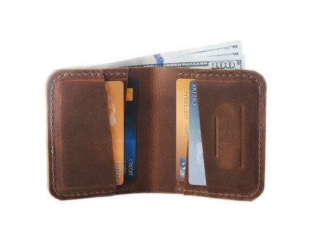 Opened brown leather wallet with credit cards isolated on white