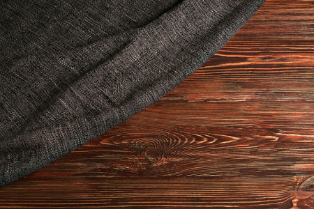 Grey knitted fabric on wooden backgroundの写真素材