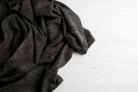 Grey knitted fabric on white wooden backgroundの写真素材