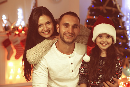 Happy family in living room decorated for Christmasの写真素材