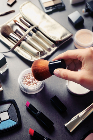 Female makeup artist hand with cosmetics at workの写真素材