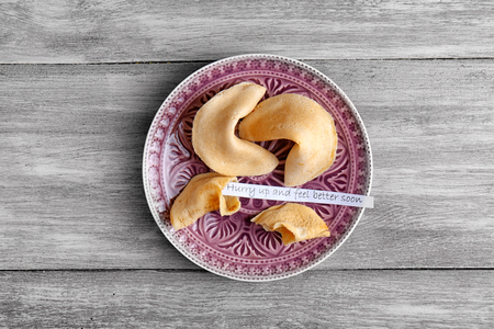 Plate with fortune cookies  on wooden backgroundの写真素材