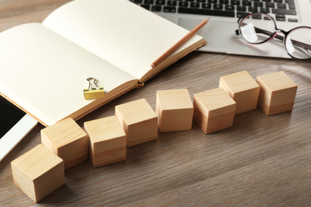 Copybook and wooden cubes on color backgroundの写真素材