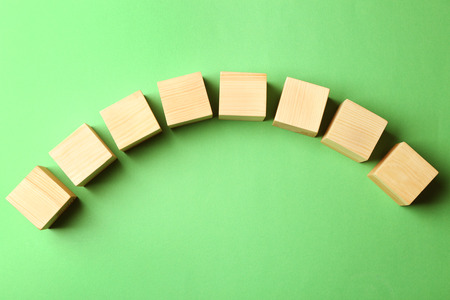 Empty wooden cubes on color backgroundの写真素材