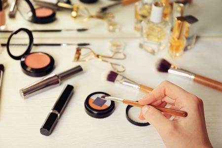 Female makeup artist hand with cosmetics at workの写真素材