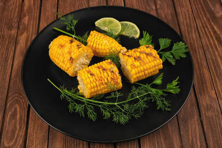 Grilled corns with ingredients on plateの写真素材
