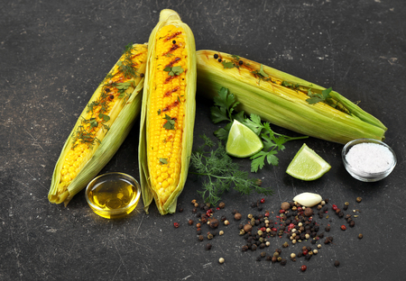 Grilled corns with ingredients on tableの写真素材