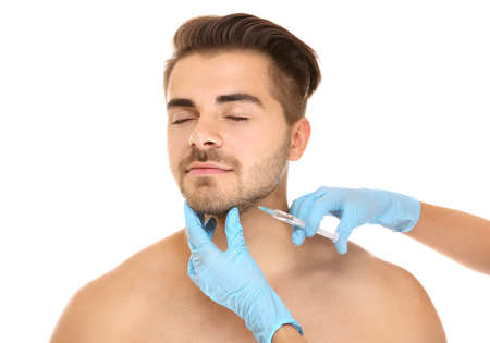 Plastic surgery concept. Man receiving injection in his faceの写真素材