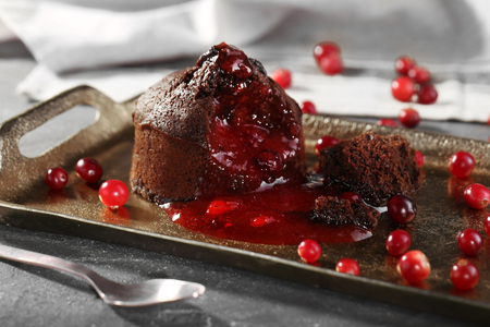 Chocolate fondant with berries on trayの写真素材
