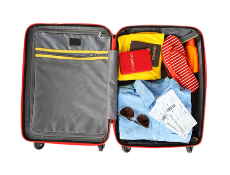 Open suitcase with traveller set on white background