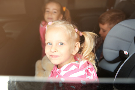 Little girl looking through car window